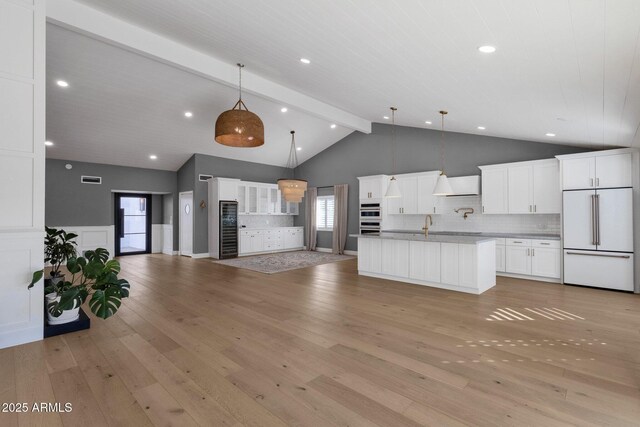 9136 N 81st St, Scottsdale, AZ 85258 - kitchen with white cabinetry, decorative light fixtures, custom exhaust hood, and paneled built in refrigerator