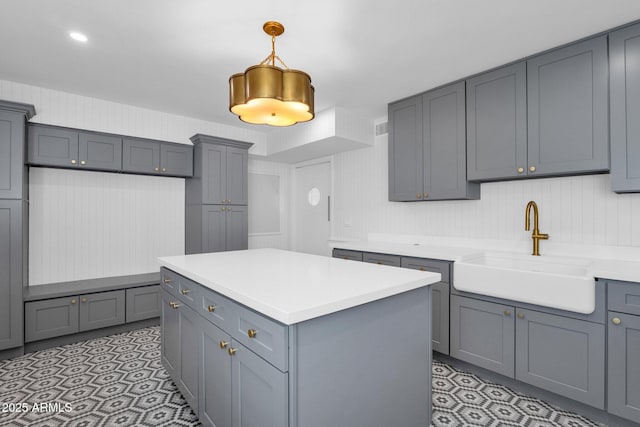 9136 N 81st St, Scottsdale, AZ 85258 - kitchen with pendant lighting, a center island, gray cabinets, and sink