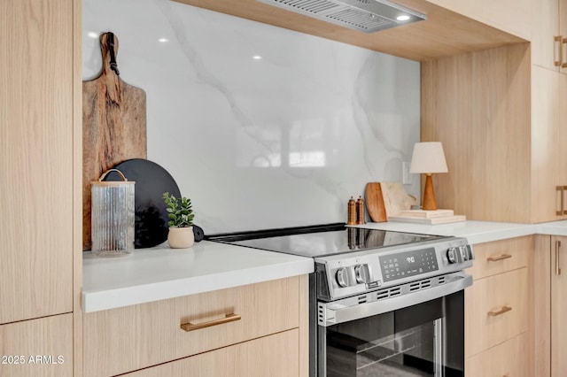 kitchen featuring stainless steel range with electric cooktop and light brown cabinets