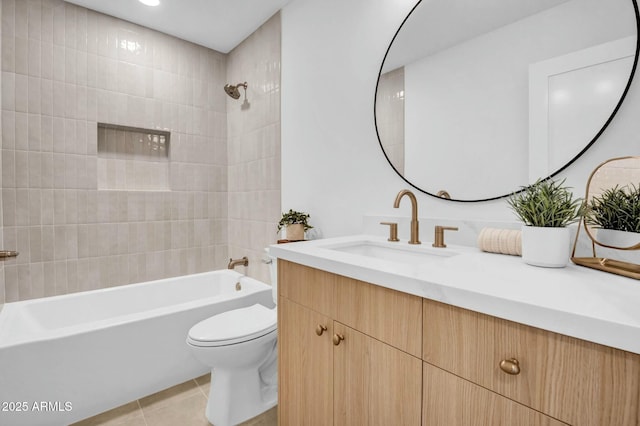 full bathroom featuring tile patterned floors, toilet, tiled shower / bath combo, and vanity