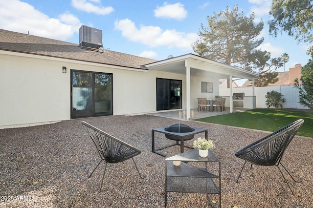 rear view of property with a yard, a patio, and central air condition unit