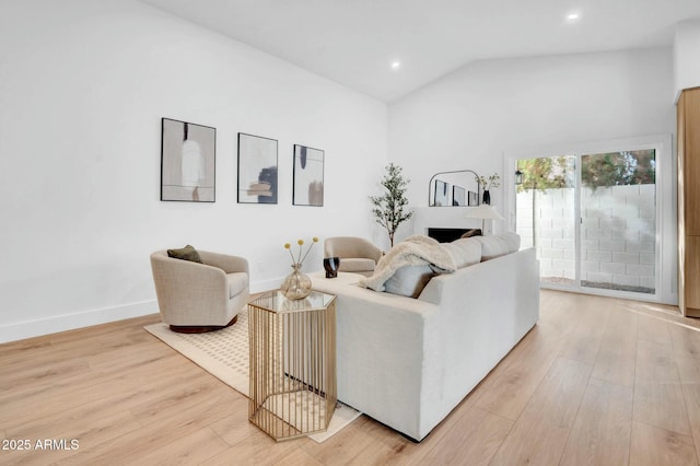 living room featuring vaulted ceiling and light hardwood / wood-style floors