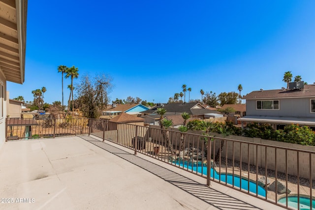 view of patio with a fenced in pool, central air condition unit, a residential view, a fenced backyard, and an in ground hot tub