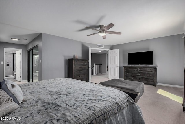 bedroom with a ceiling fan, visible vents, baseboards, ensuite bath, and light carpet