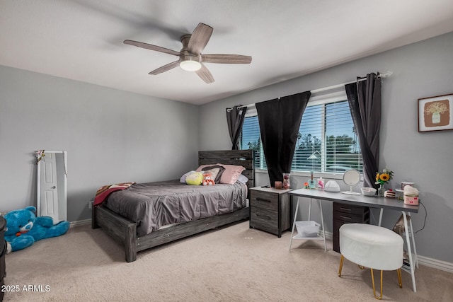 carpeted bedroom featuring baseboards and ceiling fan