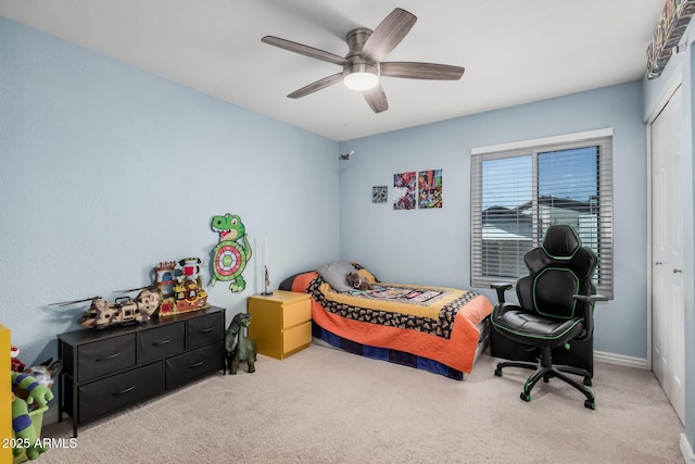 carpeted bedroom featuring a ceiling fan and a closet