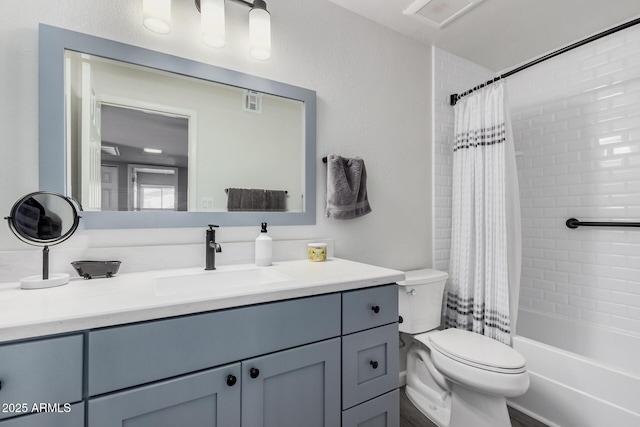 bathroom with shower / bath combo with shower curtain, toilet, vanity, and visible vents