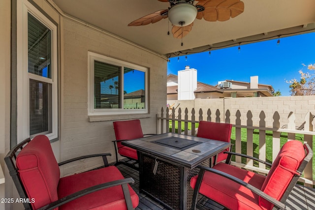 view of patio / terrace with outdoor dining area, fence, and ceiling fan