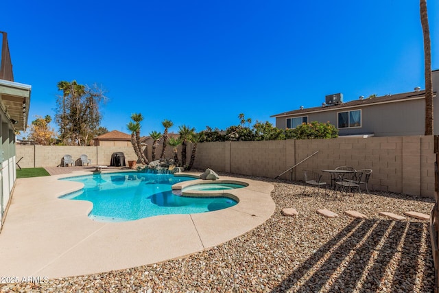 view of swimming pool featuring a patio area, central AC unit, a pool with connected hot tub, and a fenced backyard