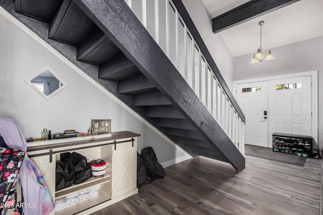 staircase with vaulted ceiling with beams and wood finished floors