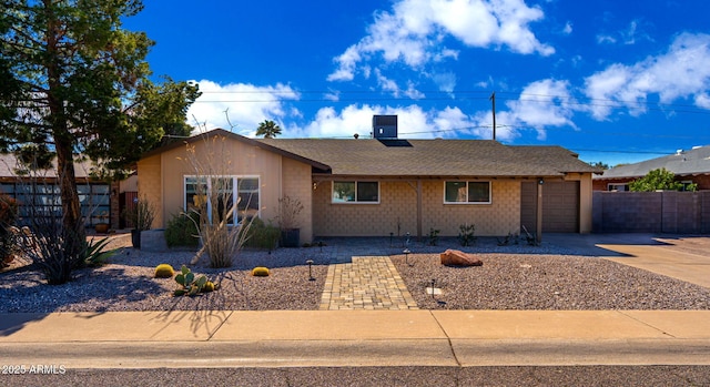 ranch-style house with cooling unit and a garage