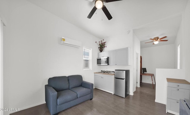 living area featuring a wall unit AC, ceiling fan, and dark hardwood / wood-style flooring