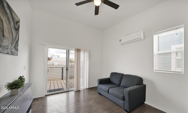 sitting room with an AC wall unit, ceiling fan, and dark hardwood / wood-style flooring