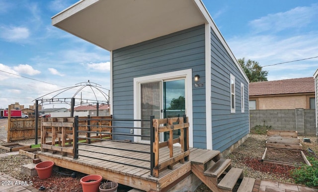 exterior space featuring a deck and a gazebo