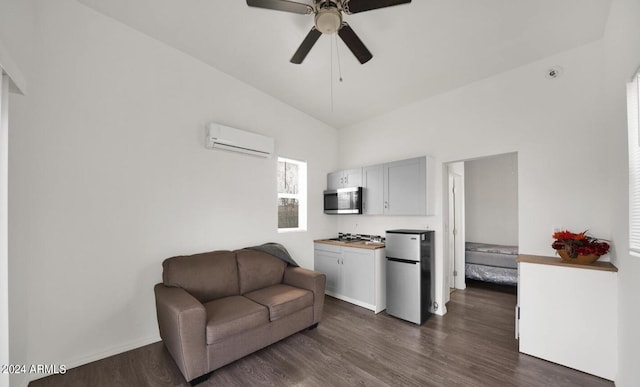 living area with a wall unit AC, dark hardwood / wood-style floors, ceiling fan, and lofted ceiling