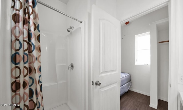 bathroom featuring wood-type flooring and a shower with curtain