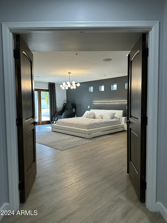 2311 E Colter St, Phoenix, AZ 85016 - bedroom featuring light wood-style floors and a chandelier