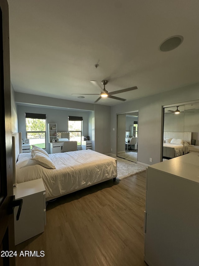 2311 E Colter St, Phoenix, AZ 85016 - bedroom featuring wood finished floors, a ceiling fan, baseboards, and multiple closets