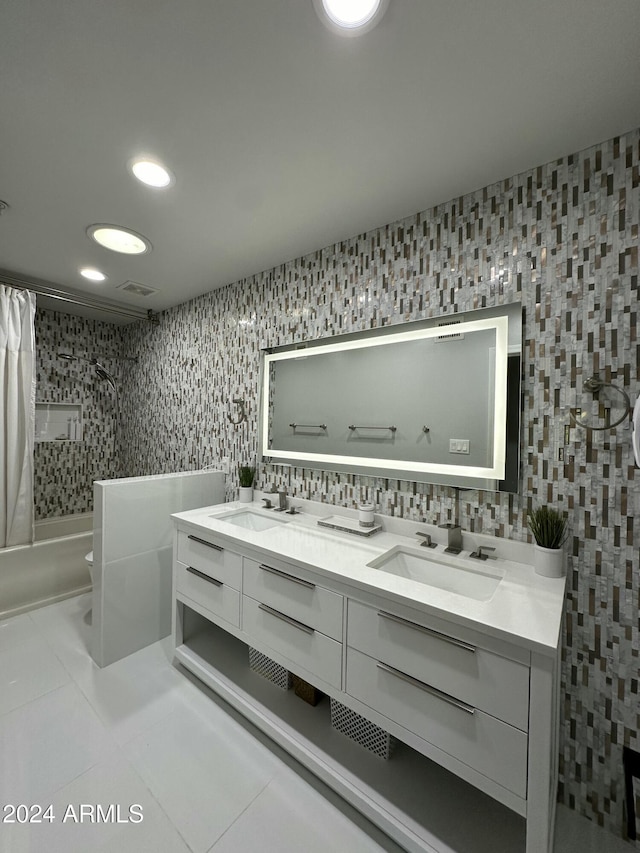 2311 E Colter St, Phoenix, AZ 85016 - bathroom with double vanity, tile patterned flooring, shower / bath combo with shower curtain, toilet, and recessed lighting