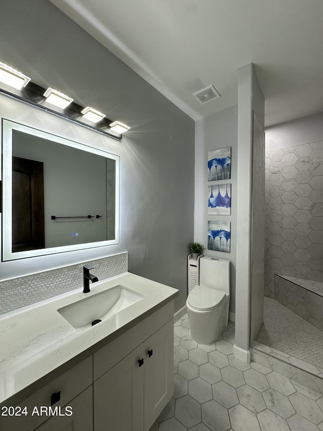 2311 E Colter St, Phoenix, AZ 85016 - full bathroom with toilet, vanity, tiled shower, and tile patterned flooring