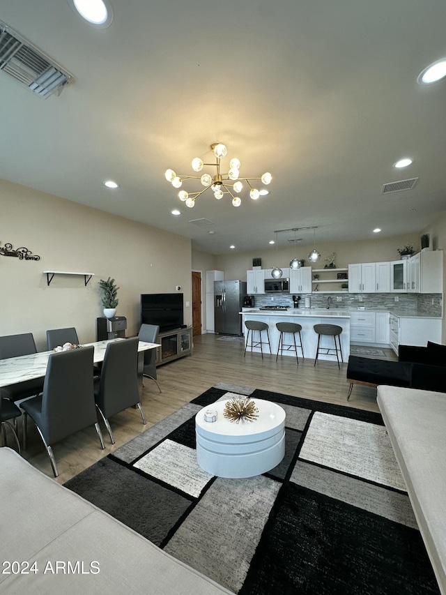 2311 E Colter St, Phoenix, AZ 85016 - living area featuring a chandelier, light wood finished floors, and recessed lighting