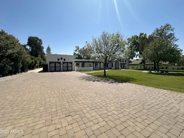 2311 E Colter St, Phoenix, AZ 85016 - view of front facade with decorative driveway, a front yard, and a garage