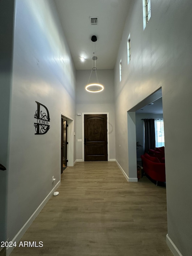 2311 E Colter St, Phoenix, AZ 85016 - hall featuring a towering ceiling, baseboards, and wood finished floors