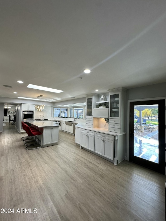 2311 E Colter St, Phoenix, AZ 85016 - kitchen featuring plenty of natural light, light countertops, recessed lighting, a center island, and light wood-style flooring