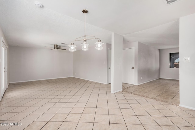 spare room featuring ceiling fan, baseboards, light tile patterned flooring, and a smoke detector