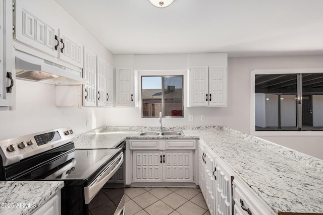 kitchen featuring stainless steel electric range, a sink, under cabinet range hood, light tile patterned floors, and white cabinets