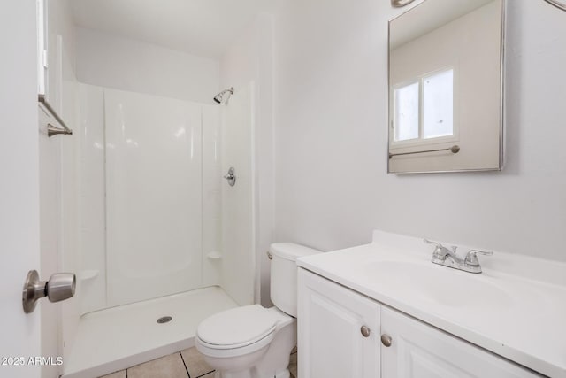 bathroom with toilet, a shower, vanity, and tile patterned flooring