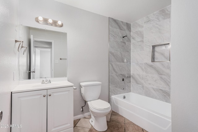 bathroom with tile patterned flooring, toilet, vanity, and shower / bathtub combination