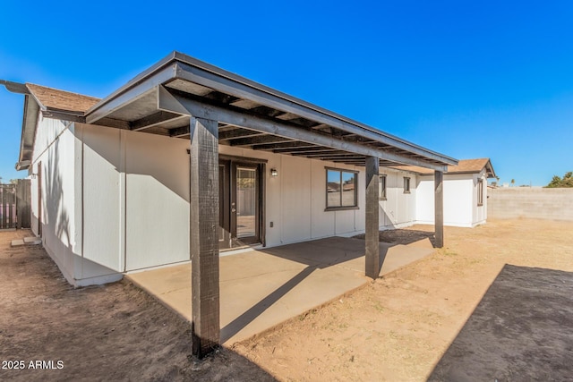 rear view of property with a patio area and a fenced backyard