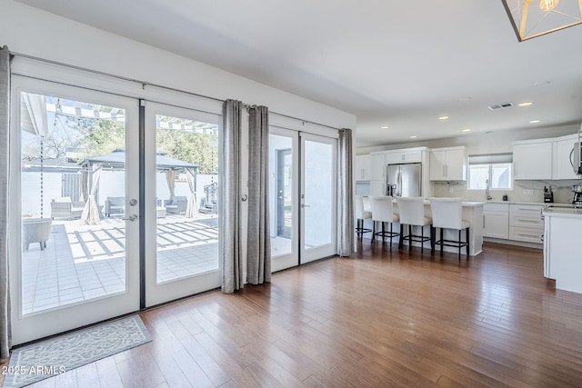 interior space featuring dark wood finished floors, visible vents, recessed lighting, and french doors