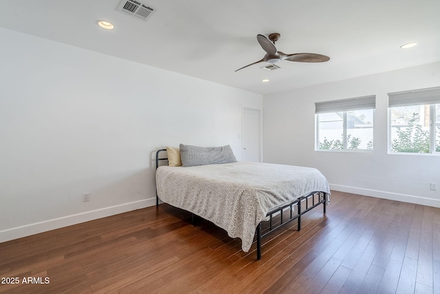 bedroom featuring visible vents, baseboards, and wood finished floors