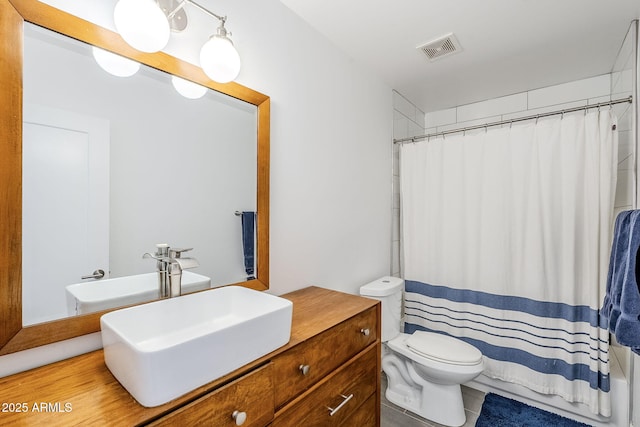 bathroom featuring visible vents, shower / bathtub combination with curtain, toilet, and vanity