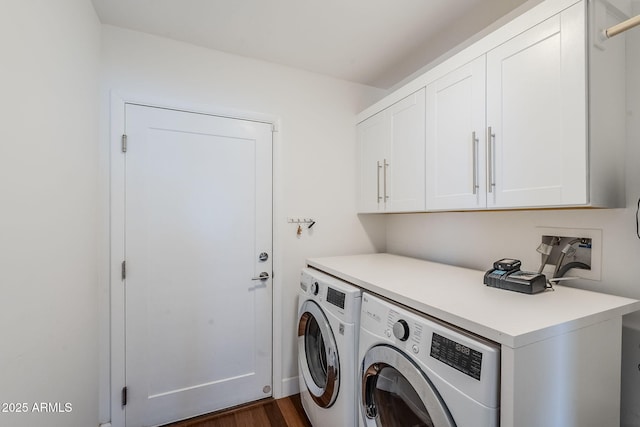 laundry area with cabinet space, washing machine and dryer, and dark wood finished floors