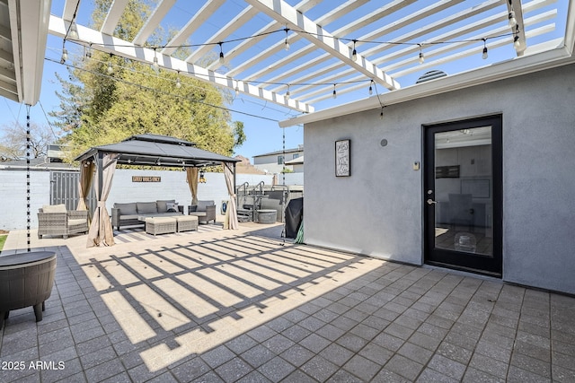 view of patio / terrace featuring a gazebo, an outdoor living space, fence, and a pergola