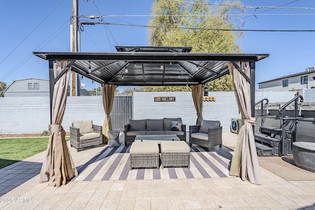 view of patio featuring outdoor lounge area, a gazebo, and a fenced backyard