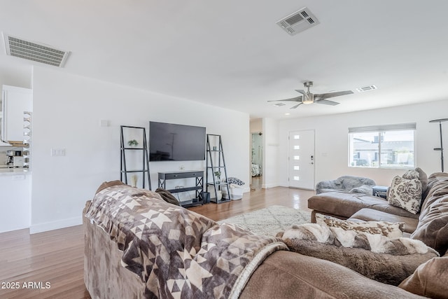 living room with visible vents and light wood-type flooring