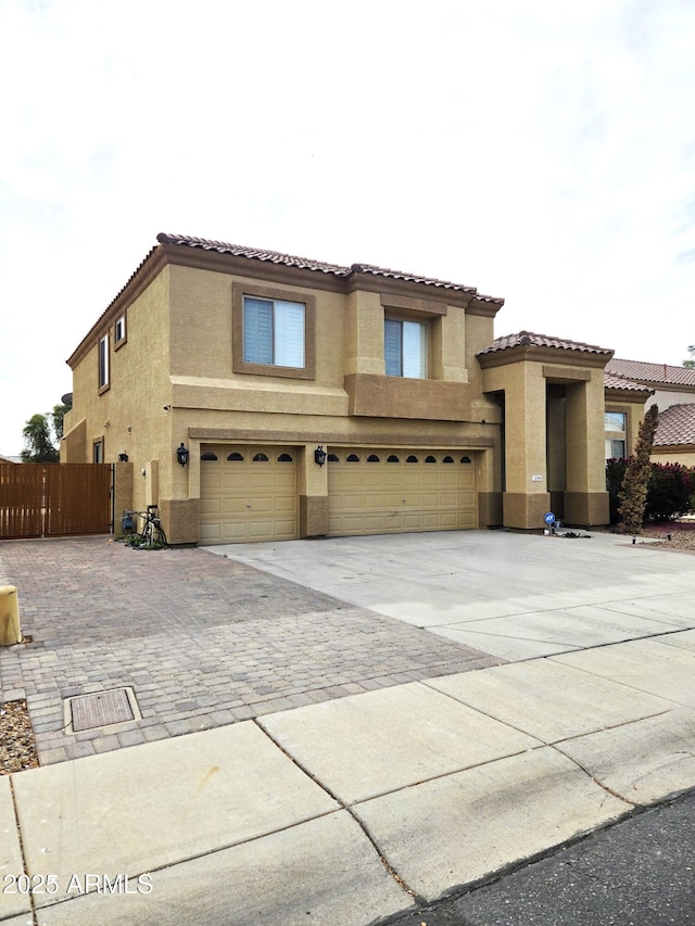 mediterranean / spanish house with a garage