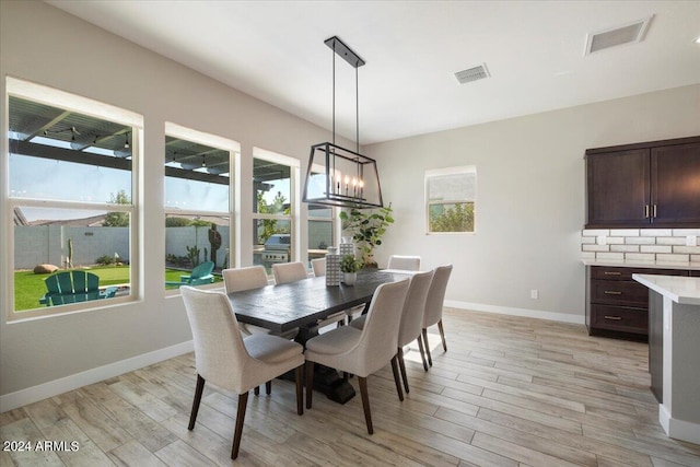 dining room featuring a chandelier and light wood-type flooring