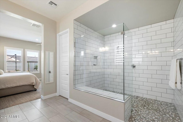 bathroom featuring tile patterned floors and a tile shower