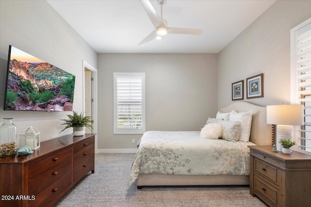 bedroom with ceiling fan and light colored carpet