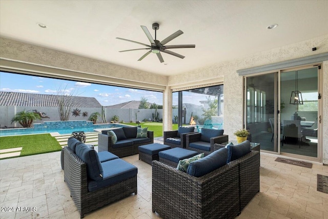 view of patio with an outdoor living space, ceiling fan, and a fenced in pool