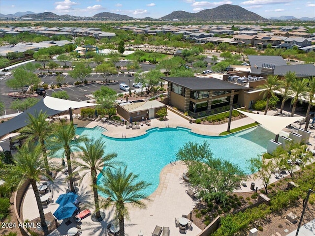 view of swimming pool with a mountain view and a patio