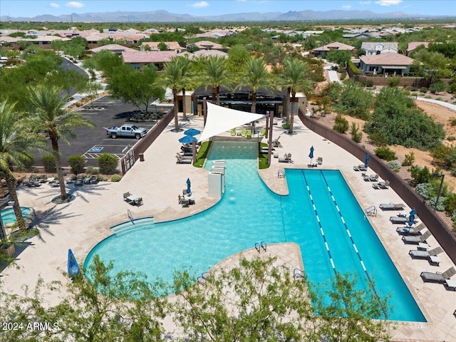 view of swimming pool with a mountain view and a patio