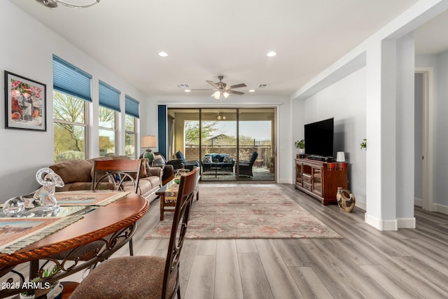 living room featuring ceiling fan and light wood-type flooring