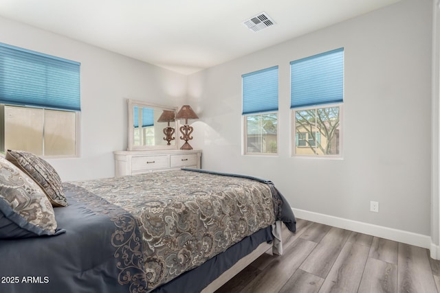 bedroom with hardwood / wood-style flooring