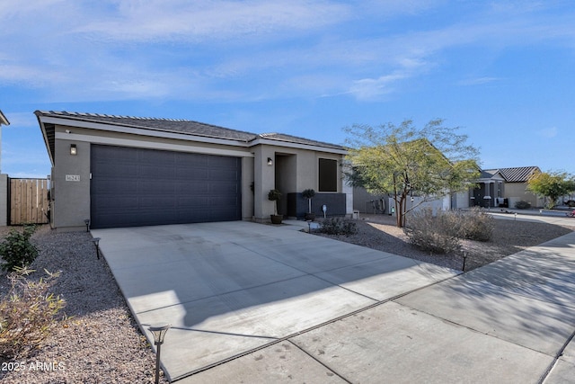 view of front of property with driveway, an attached garage, and stucco siding